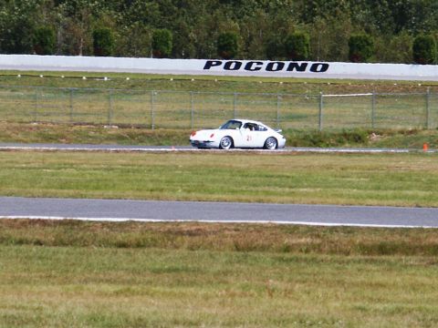 2001 Mercury Grand Marquis - A white Porsche 911 is seen on the Pocono racetrack, displaying the number 21.