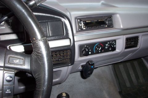1995 Ford Bronco - Interior view of a 1995 Ford Bronco, showing the dashboard, steering wheel, and center console with radio and climate controls.