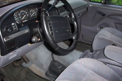 1995 Ford Bronco - Interior view of a 1995 Ford Bronco, the dashboard, steering wheel, and front seats.