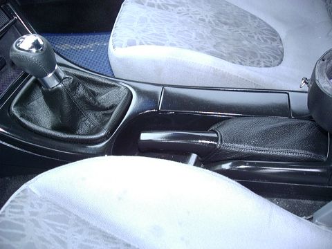 1995 Ford Probe - Close-up of a car's interior console with a manual gear shifter and handbrake visible.