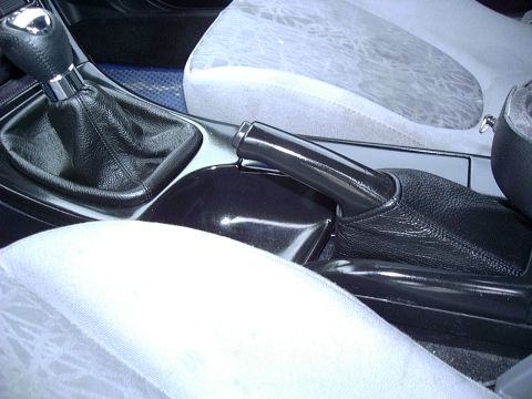 1995 Ford Probe - Close-up of the center console area of a car, the gear shifter and parking brake.