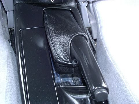 1995 Ford Probe - Interior view of the center console and parking brake handle in a 1995 Ford Probe.