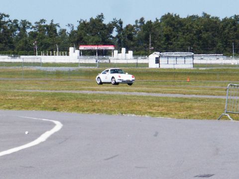2001 Mercury Grand Marquis - A white sports car navigates a turn on the Pocono Raceway track.