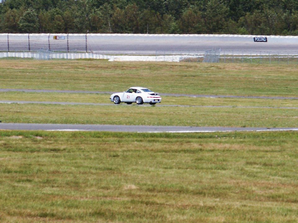 White sports car with number 21 on the door on a race track