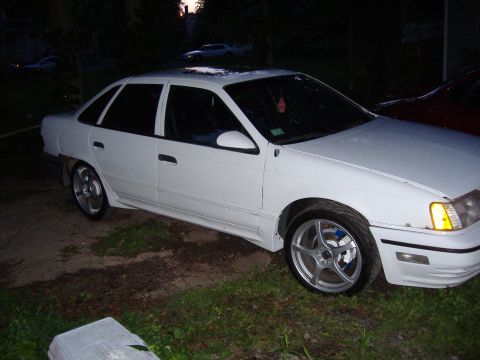 1998 Ford Taurus - This white 1998 Ford Taurus sedan is shown from a 3/4 front angle.