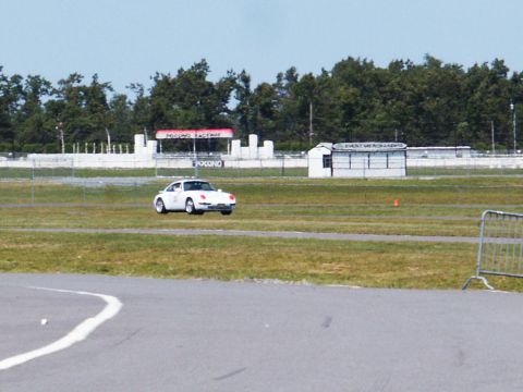 2001 Mercury Grand Marquis - A white sports car is seen on the grounds of Pocono Raceway under a clear sky.