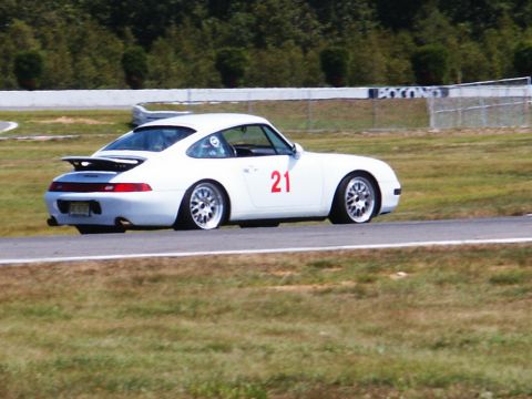 2001 Mercury Grand Marquis - A white Porsche 911 with racing number 21 is on a race track.