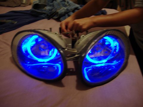 1998 Ford Taurus - Aftermarket headlights with blue halo lighting are shown, likely for a vehicle modification.