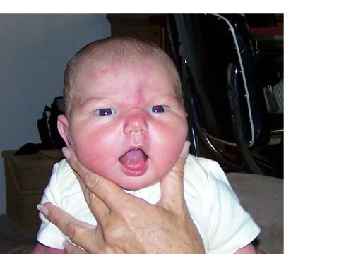 1995 Ford Bronco - A baby's face is shown close-up, with a hand supporting its chin.