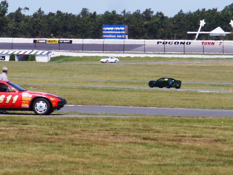 2001 Mercury Grand Marquis - Multiple cars race on a track with advertisements for Pepsi and Goodyear visible in the background.