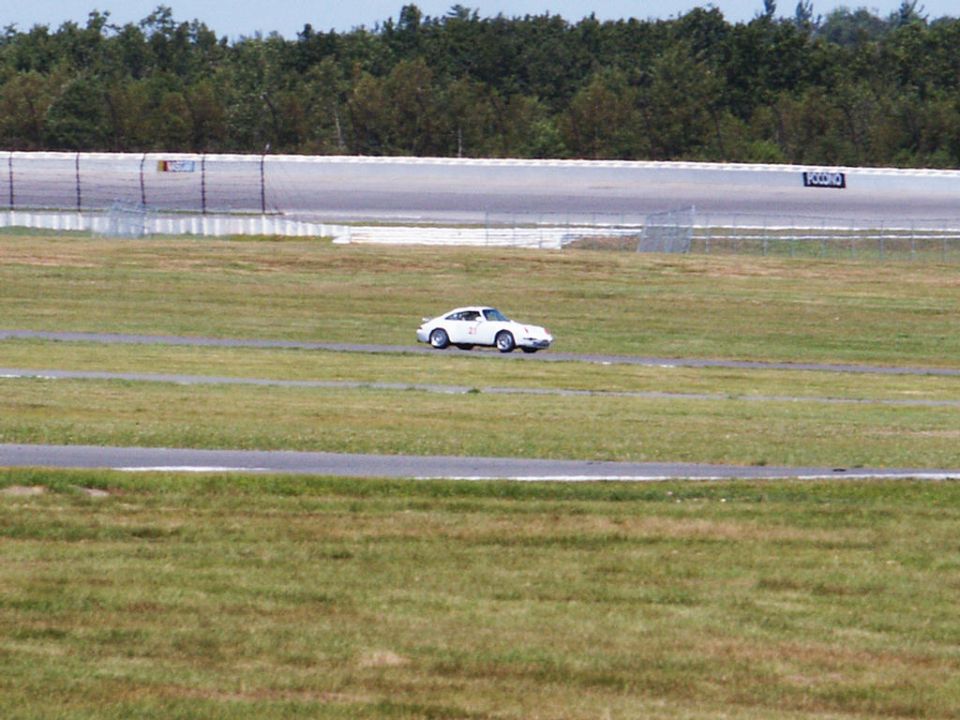 White sports car on a racetrack, side view