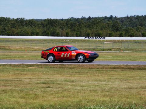 2001 Mercury Grand Marquis - A red race car numbered 611 drives on a track with 'Pocono' visible on the barrier.