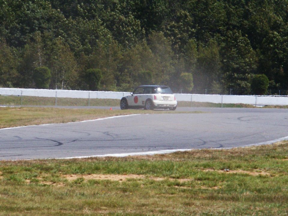 White Mini Cooper on race track, rear view
