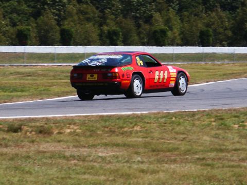 2001 Mercury Grand Marquis - A red race car with the number 611 displayed prominently on its side and rear is seen on a track.