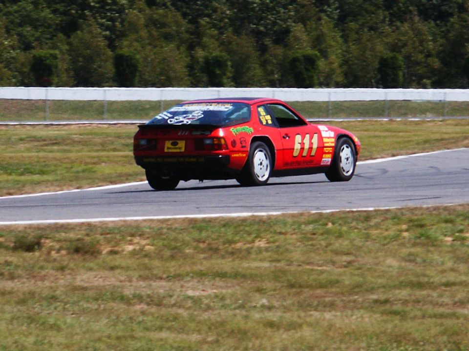 Red race car with number 611 on door and rear spoiler