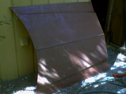 1973 Ford Ranchero - A single vehicle hood is shown leaning against a building. The registry claims it is from a 1973 Ford Ranchero.