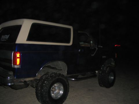 1989 Ford Bronco - This 1989 Ford Bronco is seen at night with its distinctive white removable top and large off-road tires.