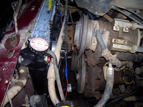 1989 Ford Bronco II - Close-up view of an engine bay, highlighting a recently installed radiator and associated parts, with readable text on the cap.