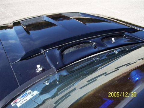 1969 Ford Mustang - Close-up of a 1969 Ford Mustang hood, showing its distinctive vents and hood pins.