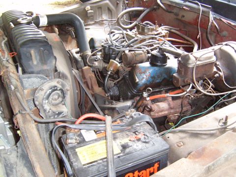 1993 Ford Bronco - Engine bay of a Ford vehicle, showing the V8 engine, battery, and radiator.
