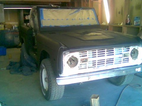 1991 Ford Explorer - This Ford Bronco appears to be undergoing bodywork in a garage, with its grille masked for painting.