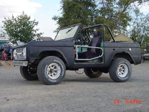 1991 Ford Explorer - This black early Bronco is missing its doors and features a roll cage and aftermarket wheels.
