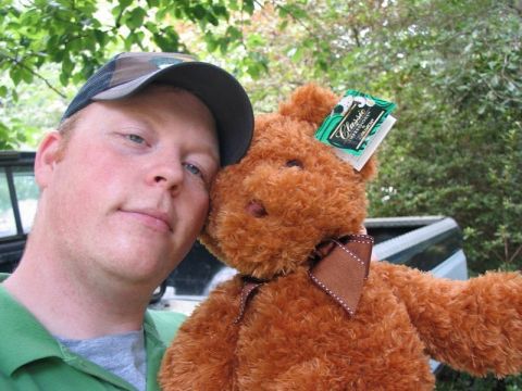 2004 Ford F-150 - A man poses with a teddy bear, with the bed of a truck visible behind them.