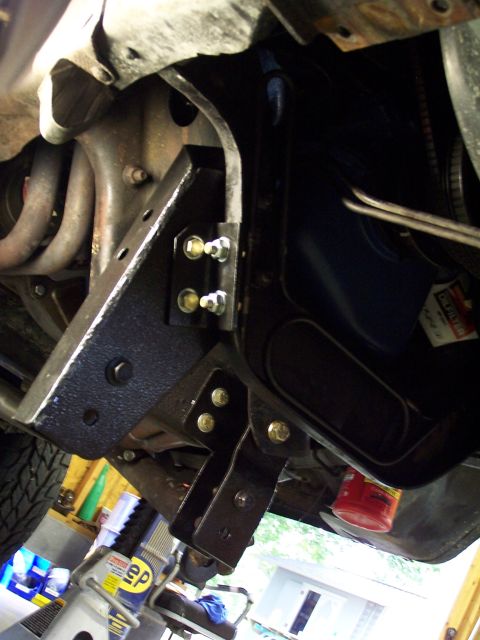 1983 Ford Bronco - Underbody view of newly installed lift kit hardware on a vehicle frame.