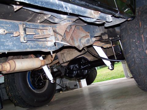 1983 Ford Bronco - The rear suspension and drivetrain components of a vehicle are shown in this underside view.
