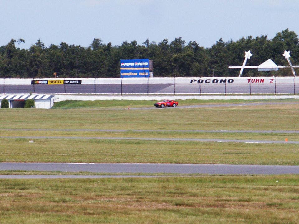 Red sports car on Pocono Raceway track