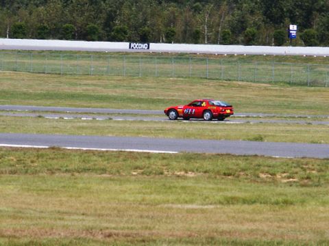 2001 Mercury Grand Marquis - A red sports car races on the Pocono track, displaying the number 611.