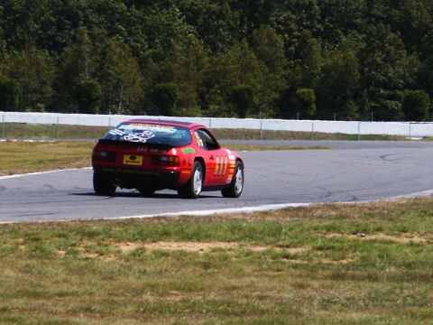 2001 Mercury Grand Marquis - Red race car with decals and number 111 on a track.