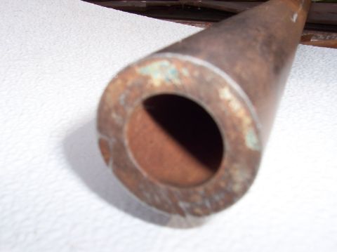 1979 Ford Bronco - Close-up of a rusted metal pipe, showing signs of age and corrosion.