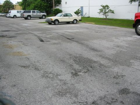 1985 Ford Crown Victoria LTD - Several vehicles parked in an outdoor lot, with a cream-colored coupe in the foreground.
