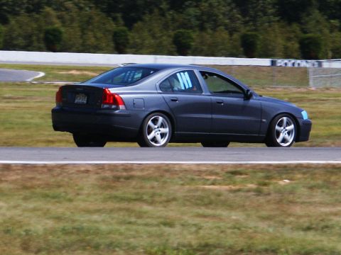 2001 Mercury Grand Marquis - A dark gray Volvo S60 is seen on a race track, displaying blue netting in the windows.