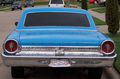 1963 Ford Galaxie - The rear of a blue 1963 Ford Galaxie is shown with its distinctive taillights and chrome bumper.