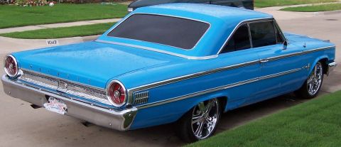 1963 Ford Galaxie - This blue 1963 Ford Galaxie is captured from a rear three-quarter angle, its classic design and chrome accents.