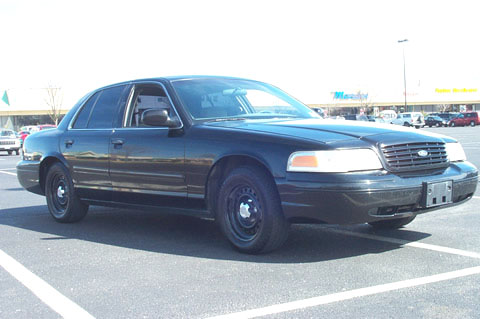 1995 Ford Crown Victoria - This 1995 Ford Crown Victoria is captured in a 3/4 front view, parked in a lot.