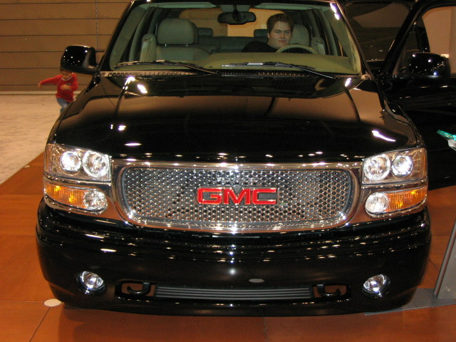 Black GMC Yukon front view with chrome grille and red GMC logo