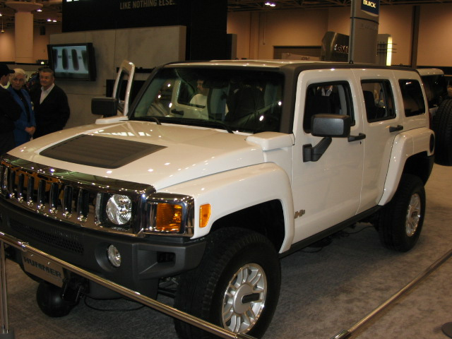 White Hummer H3 with doors open at an auto show