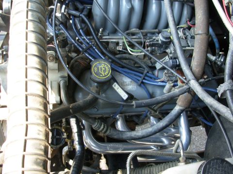 1994 Ford Bronco - Close-up view of a vehicle's engine bay, showing various mechanical parts and wiring.