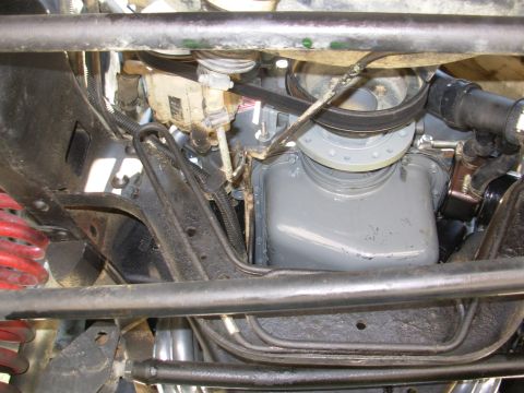 1994 Ford Bronco - Close-up view of the engine bay, showing the oil pan and drive belt system.