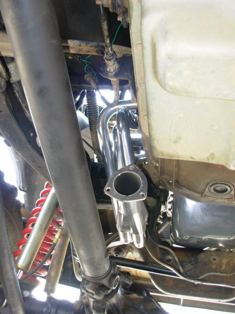 1994 Ford Bronco - Underside view of a vehicle's engine bay, focusing on the exhaust system and drivetrain components.