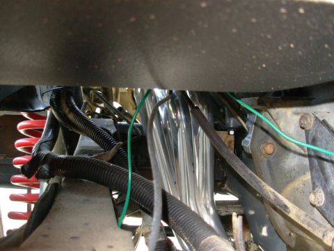 1994 Ford Bronco - Close-up view of engine bay components, including exhaust headers and suspension springs.