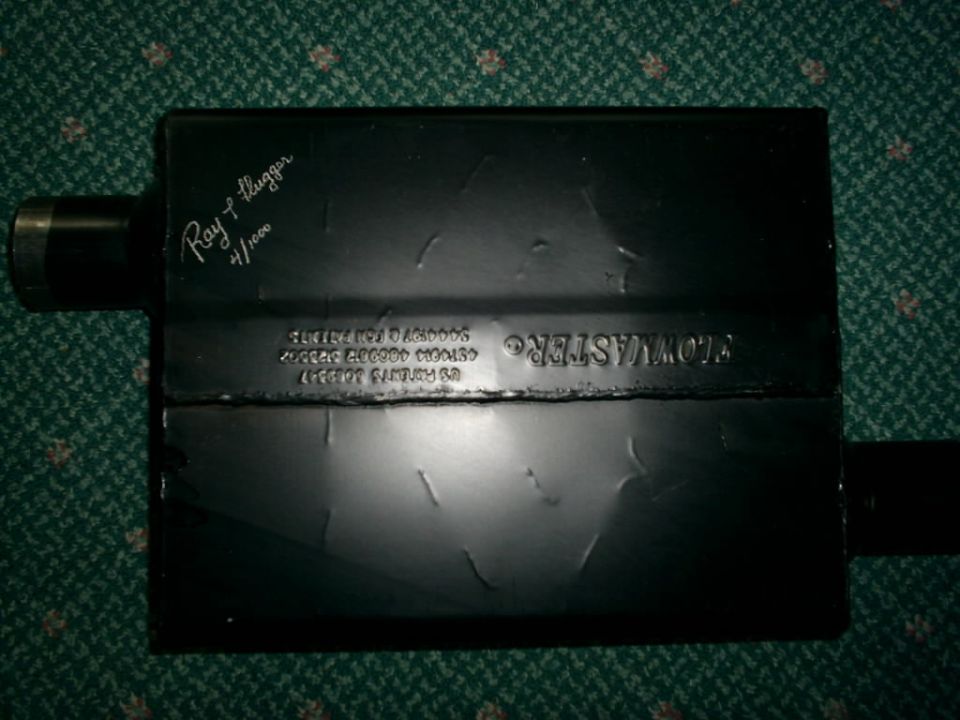 Black Flowmaster muffler with "Ray P. Flugger 4/1000" written on top and patent information stamped on the side