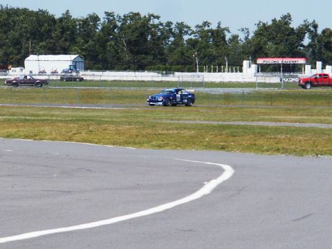 2001 Mercury Grand Marquis - Cars compete on a raceway, with 'POCONO RACEWAY' visible on a sign.