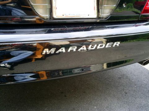 2003 Mercury Marauder - Rear view of a black 2003 Mercury Marauder, showing the MARAUDER badging on the bumper.