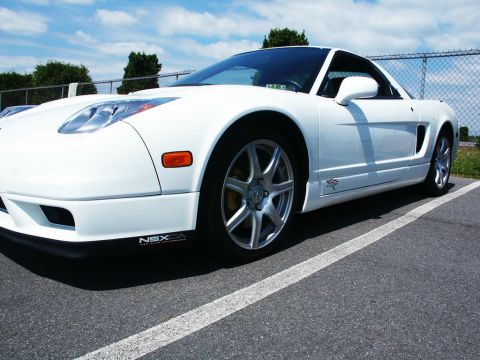 2001 Mercury Grand Marquis - A white Acura NSX is parked in a lot under a partly cloudy sky.
