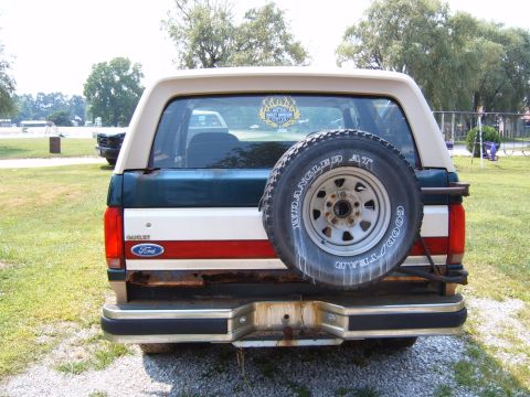 1993 Ford Bronco - Rear view of a 1993 Ford Bronco, a spare tire and a distinctive tri-color paint job.