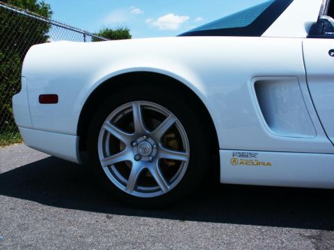 2001 Mercury Grand Marquis - Side view of a white Acura NSX showing the rear wheel and body details.